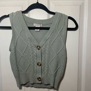 Sage green cropped sweater vest.